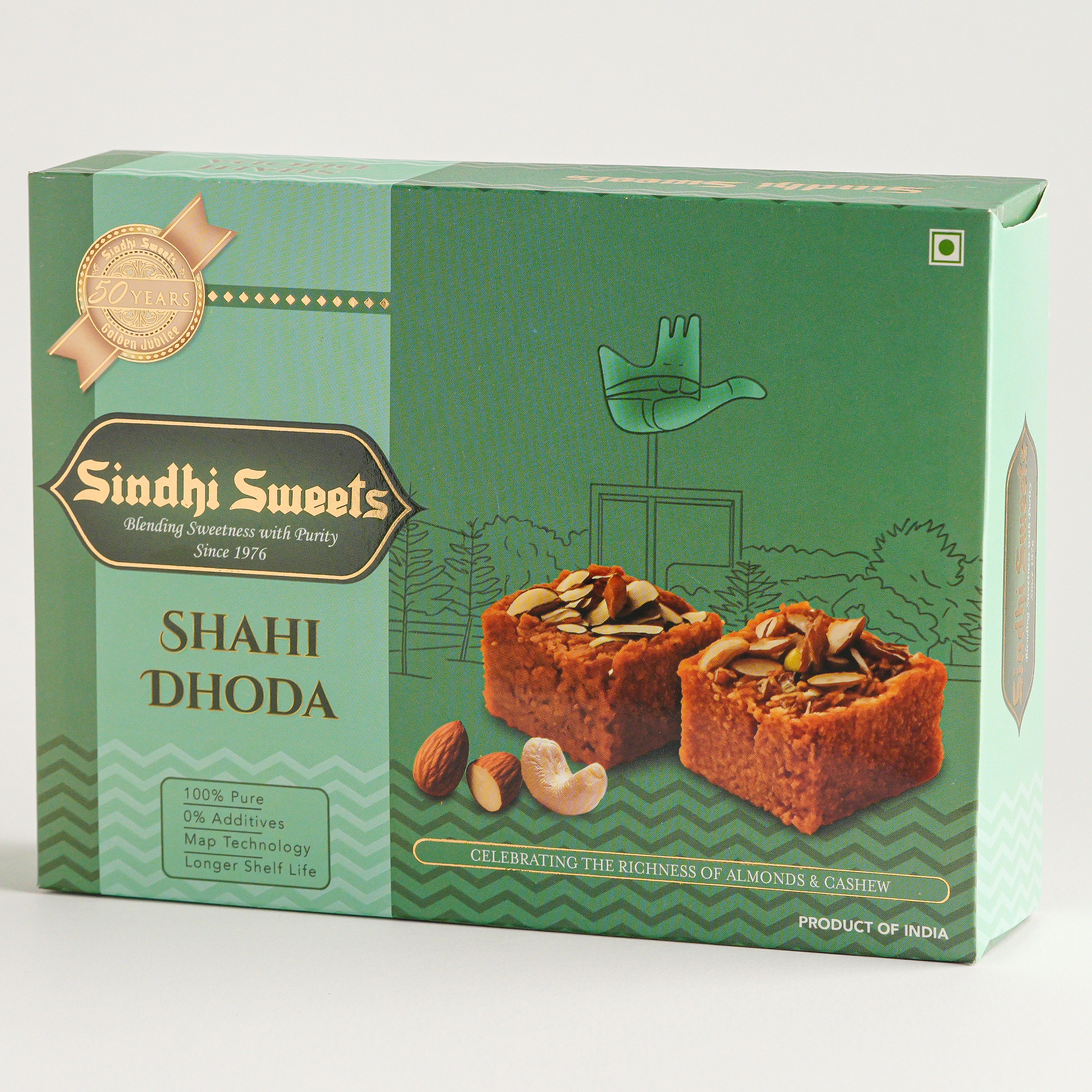 Green box of Sindhi Sweets Shahi Dhoda with sweet treats on a white background