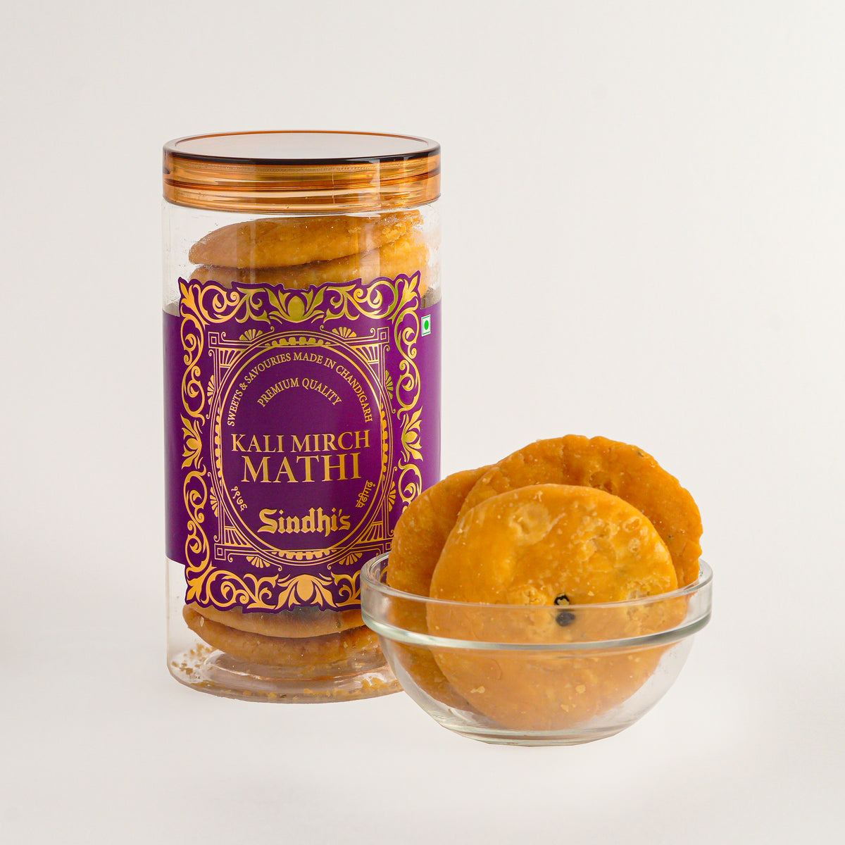 Jar of Kali Mirch Mathi with a decorative label on a white background