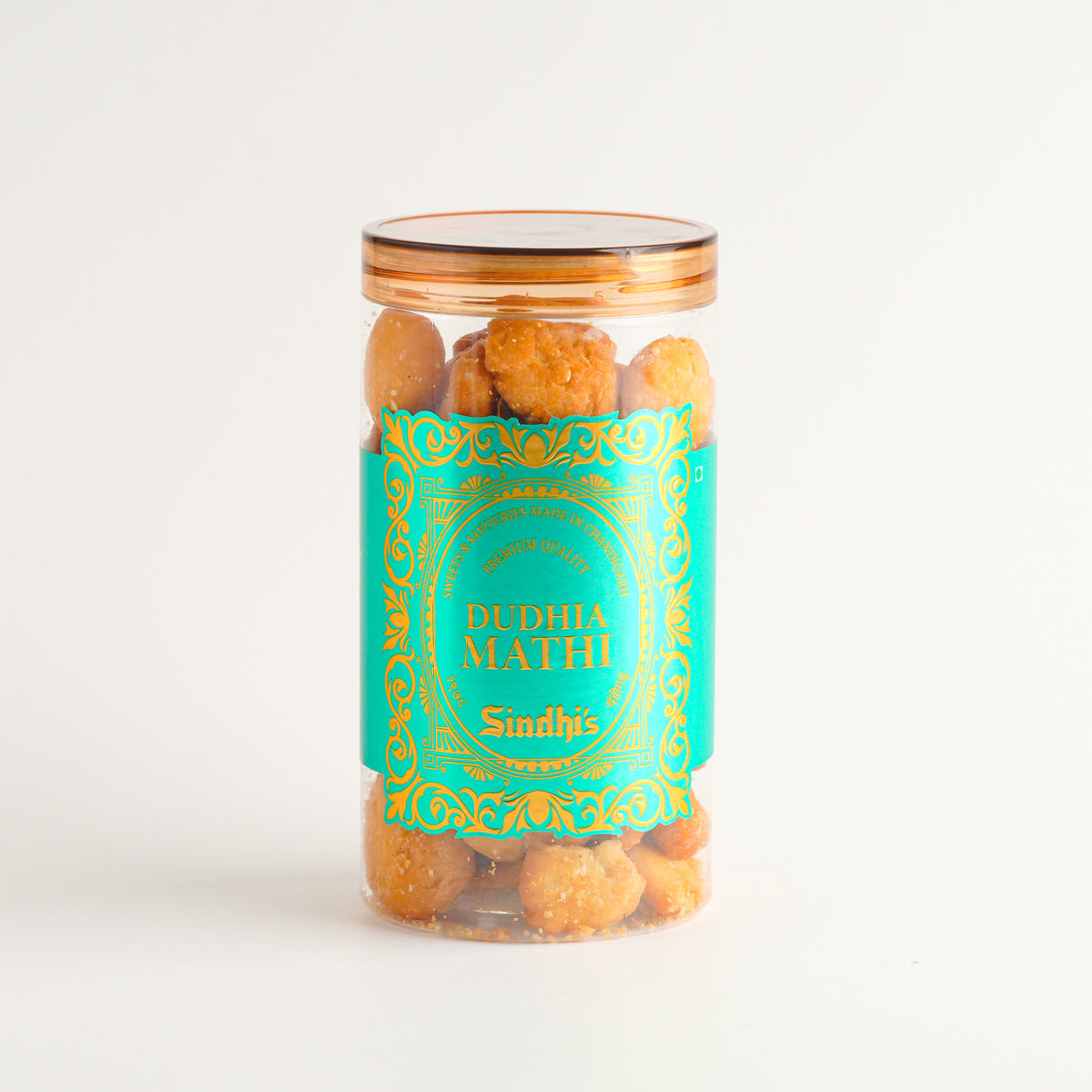 Jar of Dudhia Mathi with a decorative label on a white background