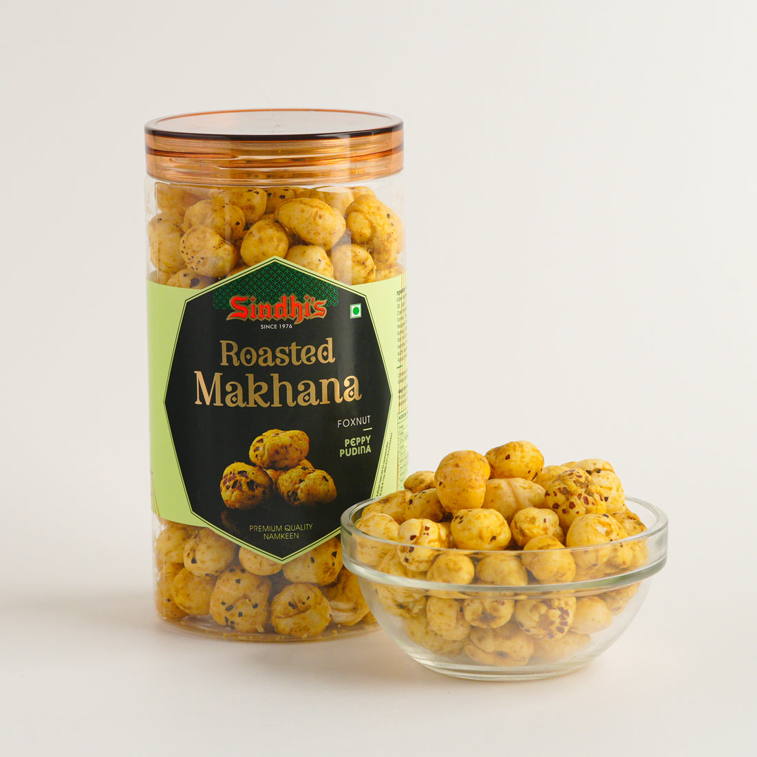 Jar and bowl of Sindhi's Roasted Makhana on a light background