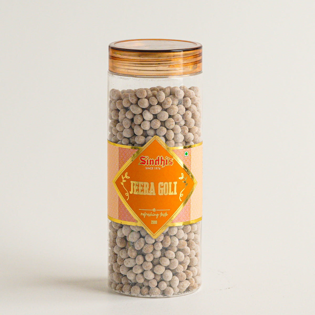 Jar of Sindhi Jeera Goli with a yellow label on a white background