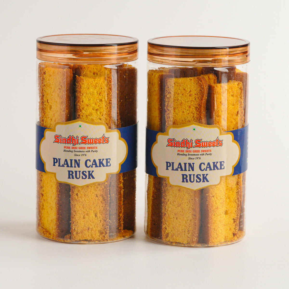 Two jars of 'Plain Cake Rusk' from 'Sindhi Sweets' on a light gray background