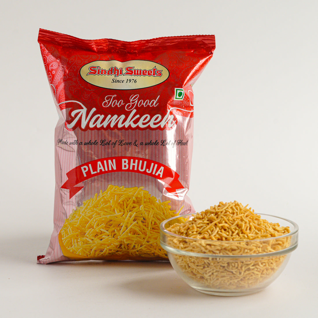 Red package of 'Too Good Namkeen' Plain Bhujia with a bowl of noodles on a white background