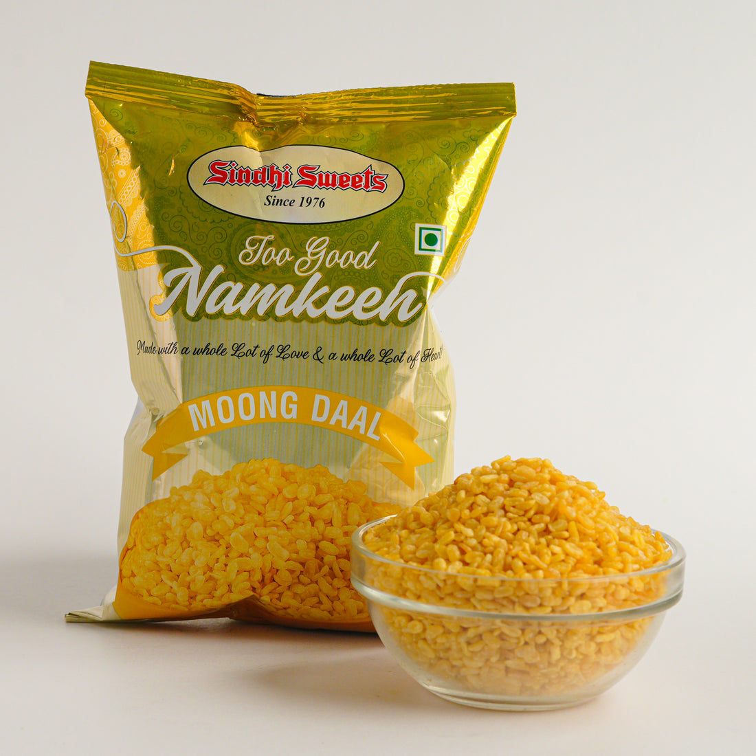 Packaged Namkeen with a bowl of Namkeen on a white background