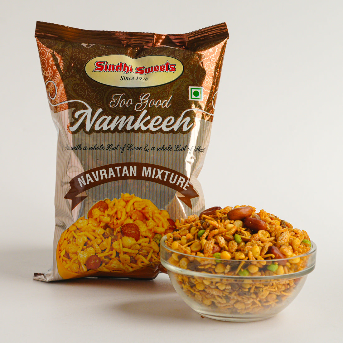 Packaged Navratan Mixture with a bowl of the product on a white background