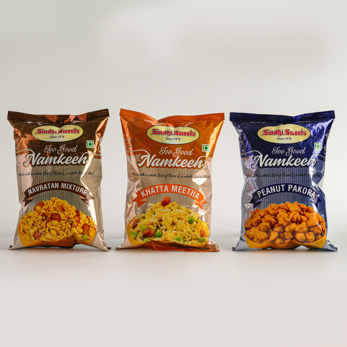Three packages of Sindhi Sweets Namkeen snacks on a white background