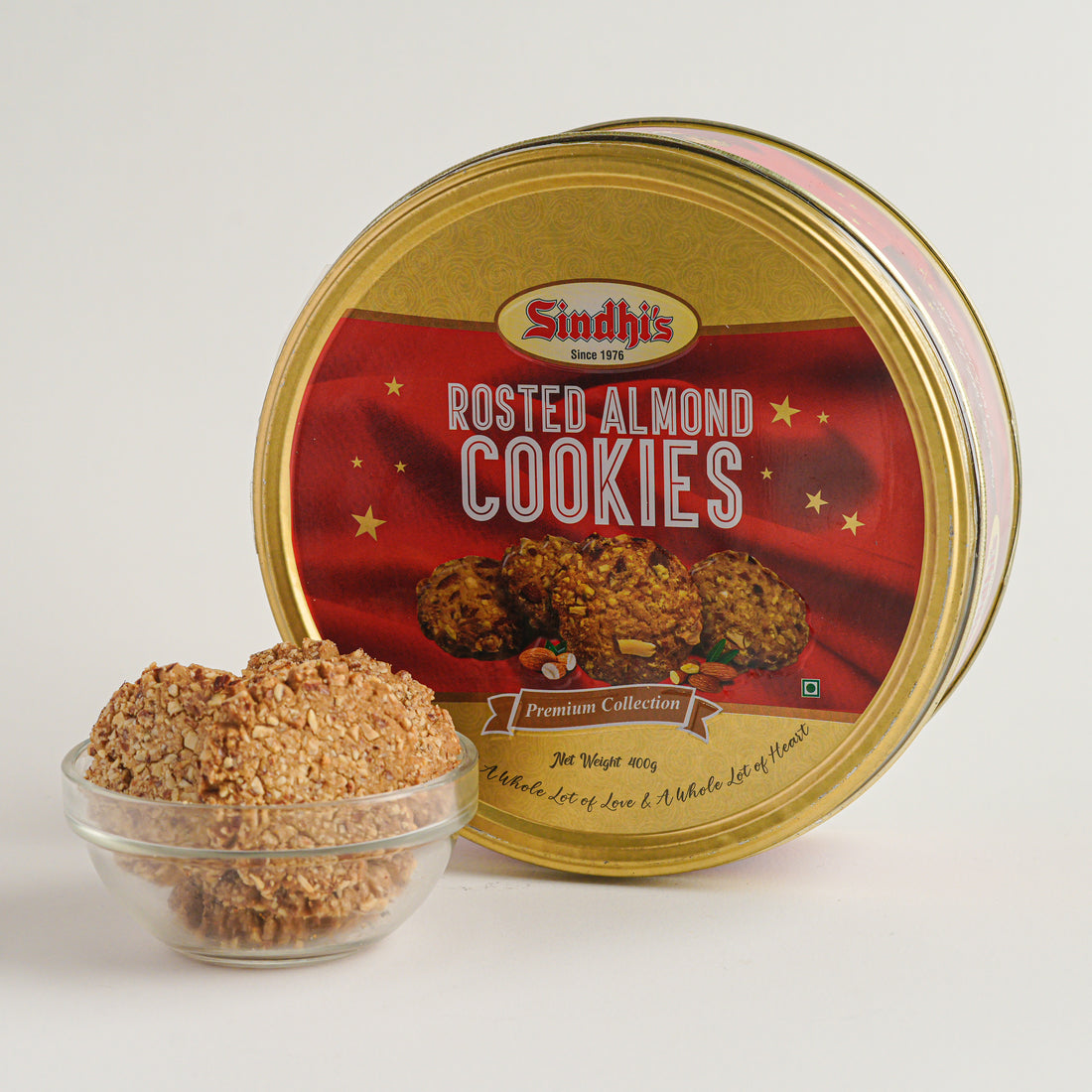 Sindhi's Roasted Almond Cookies in a gold tin with cookies displayed in front.