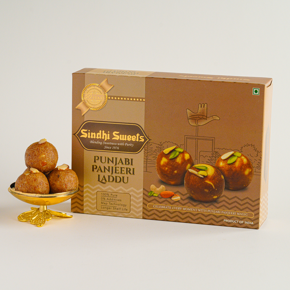 Box of Sindhi Sweets Punjabi Panjeeri Laddu with laddus on a white background