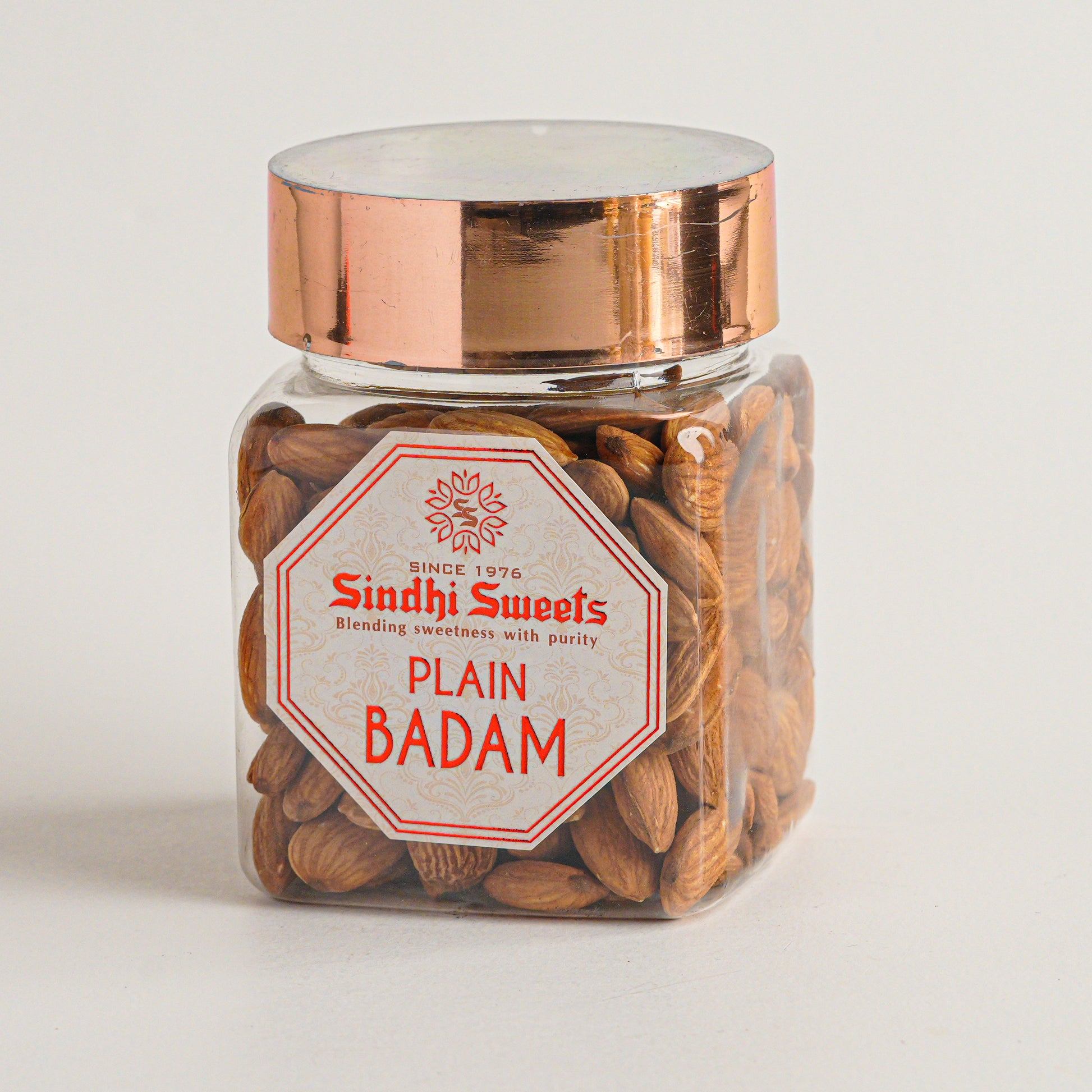 Jar of Sindhi Sweets Plain Badam on a light gray background