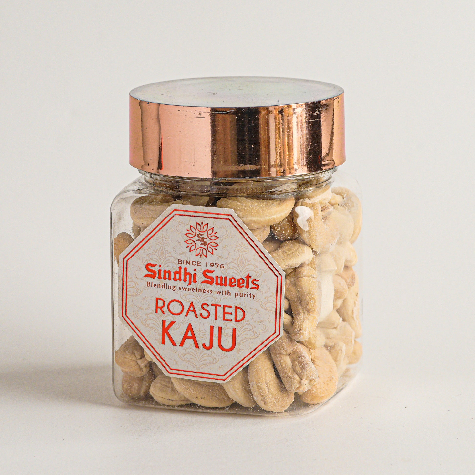 Jar of roasted cashews with a 'Sindh Sweets' label on a light background