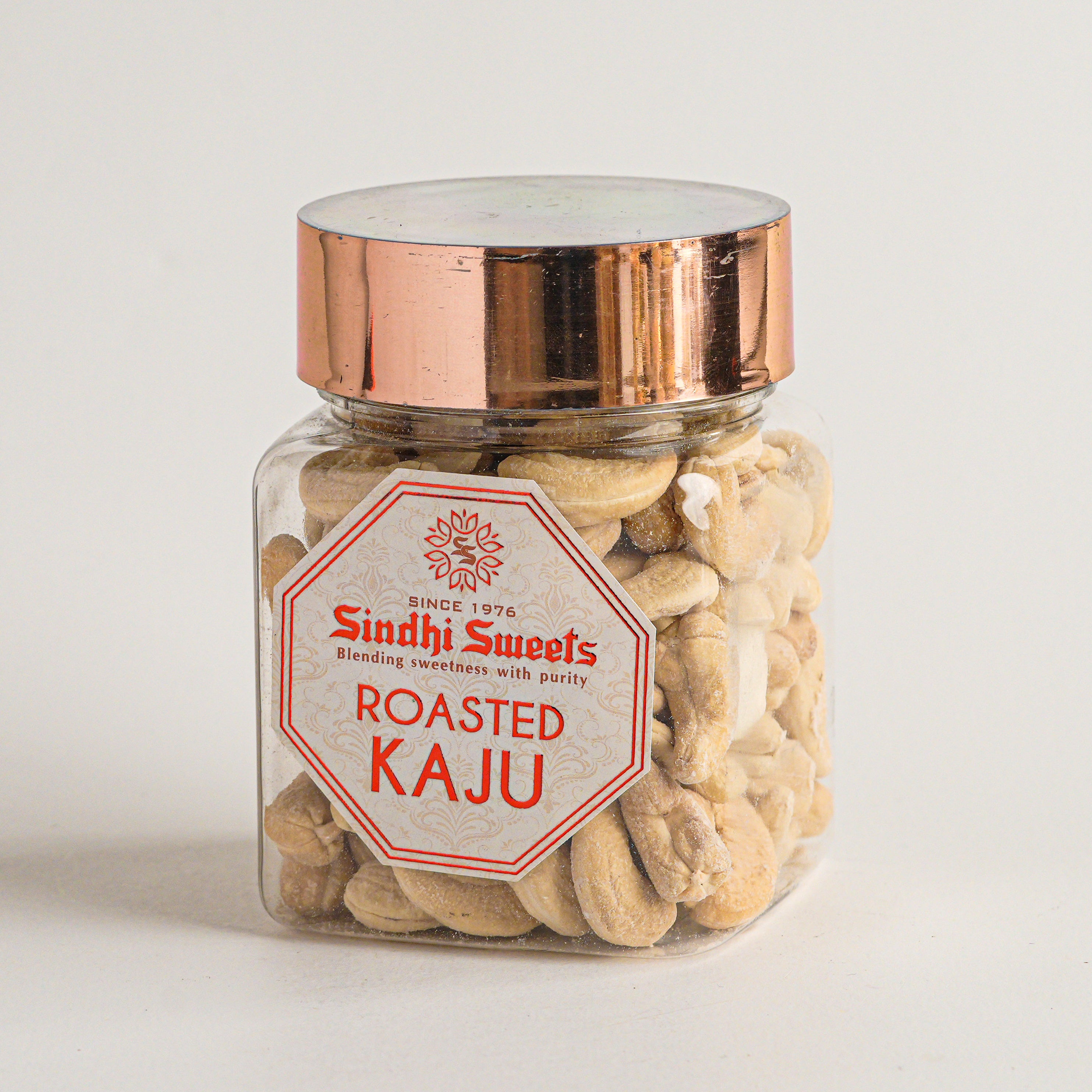 Jar of roasted cashews with a 'Sindh Sweets' label on a light background