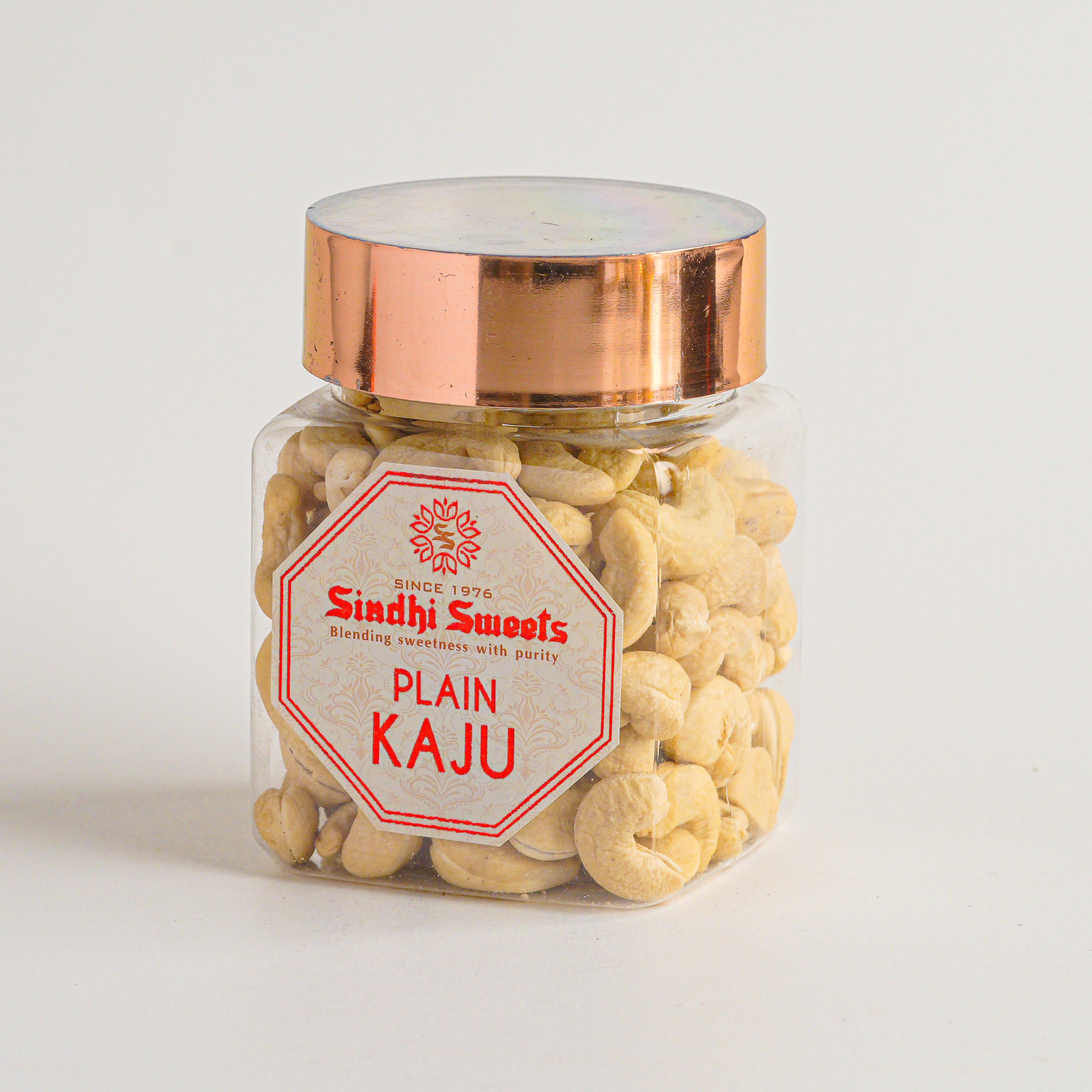 Jar of 'Plain Kaju' cashews with a 'Sindhi Sweets' label on a light background