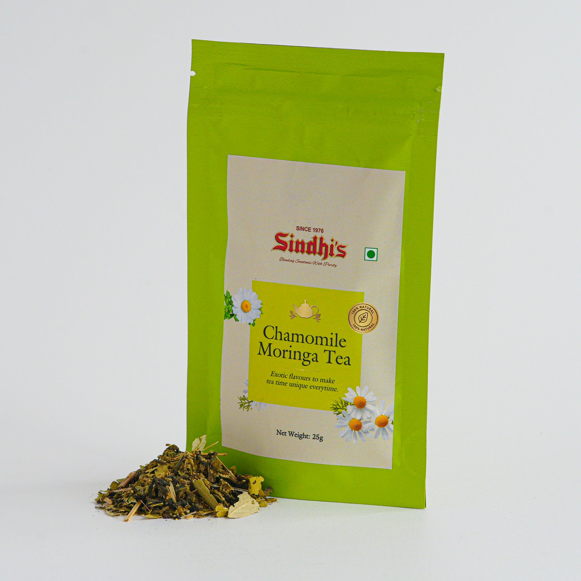 Green package of Sindhi's Chamomile Moringa Tea with loose tea leaves on a white background