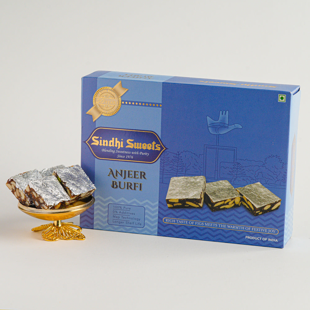 Box of Sindhi Sweets Anjeer Burfi with a small display of the sweet on a white background