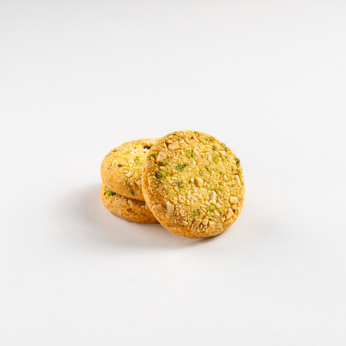 Three round cookies with a textured surface on a white background