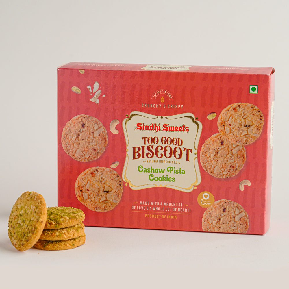 Box of Sindhi Sweets Too Good Biscoot Cashew Pista Cookies with cookies on a white background