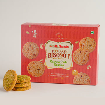 Box of Sindhi Sweets Too Good Biscoot Cashew Pista Cookies with cookies on a white background