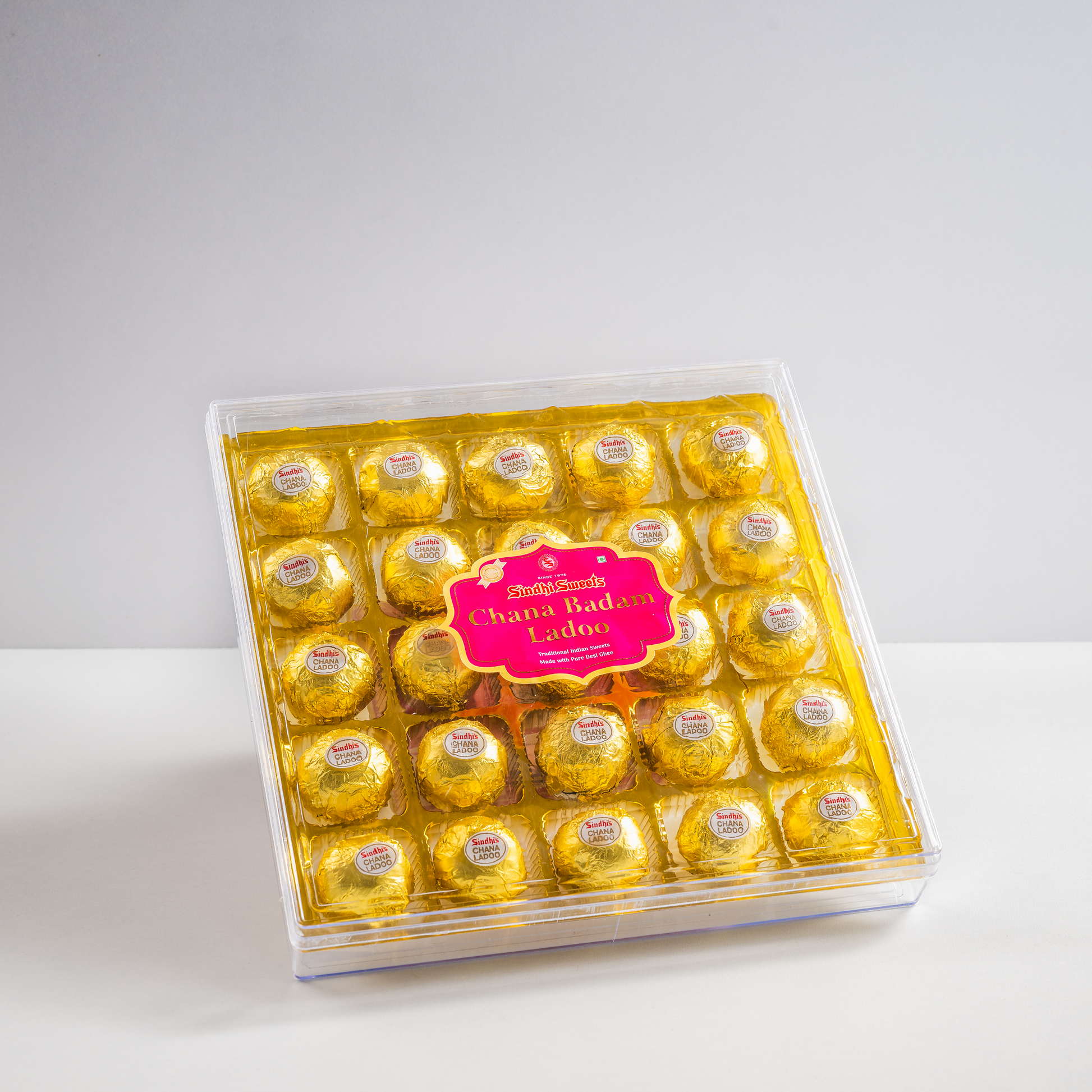 Packaged chocolates in a clear box on a white background