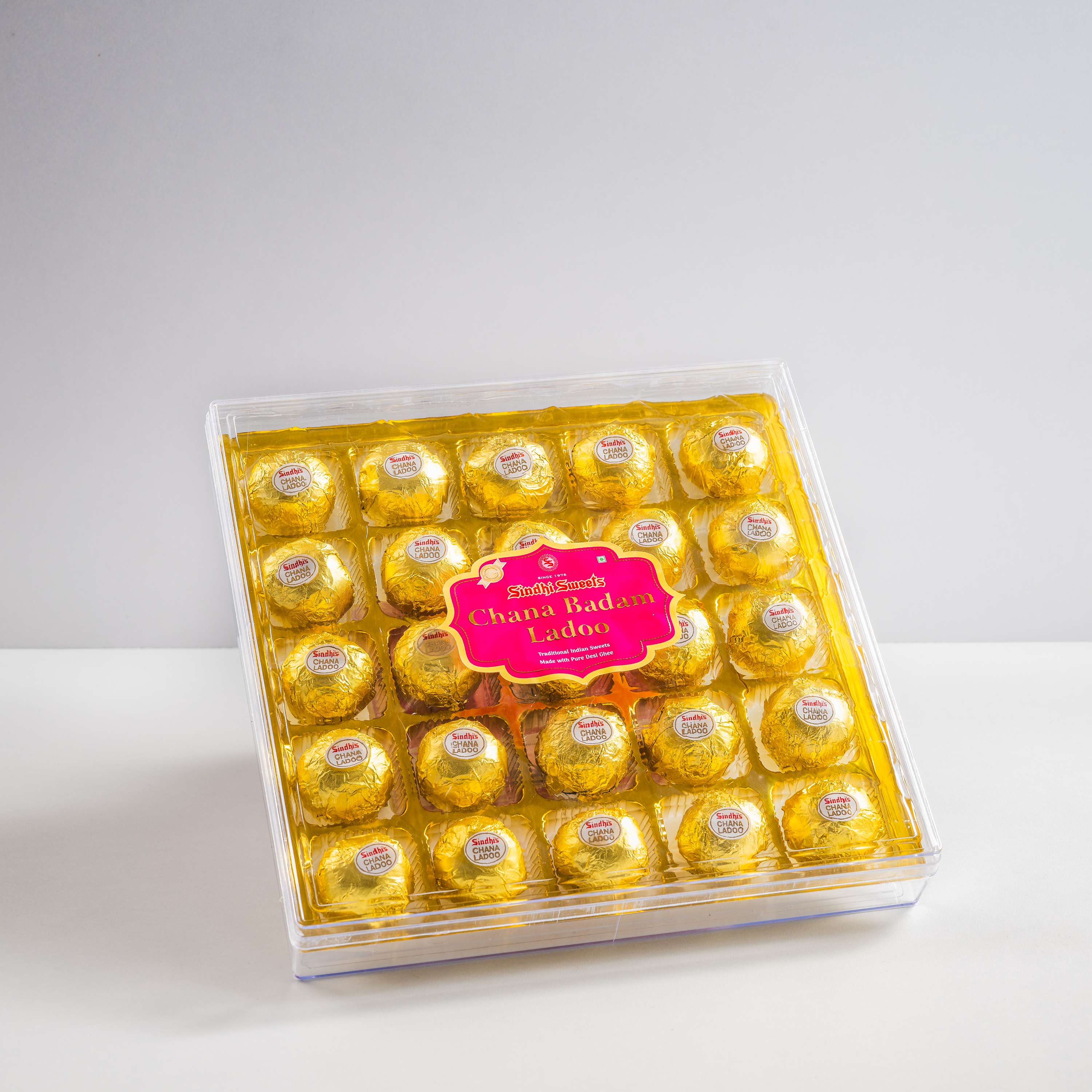 Packaged chocolates in a clear box on a white background