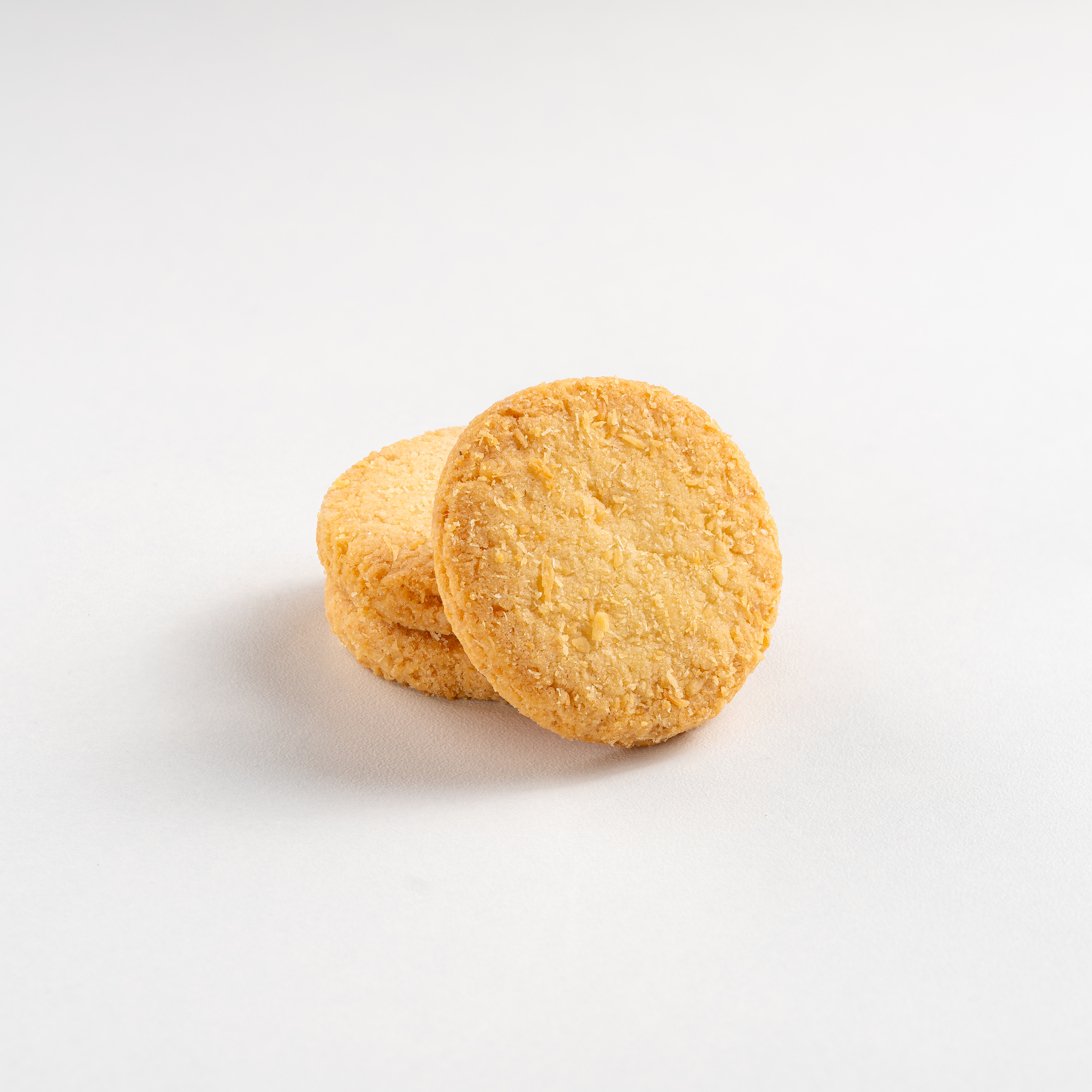 Two round, orange-colored cookies on a white background
