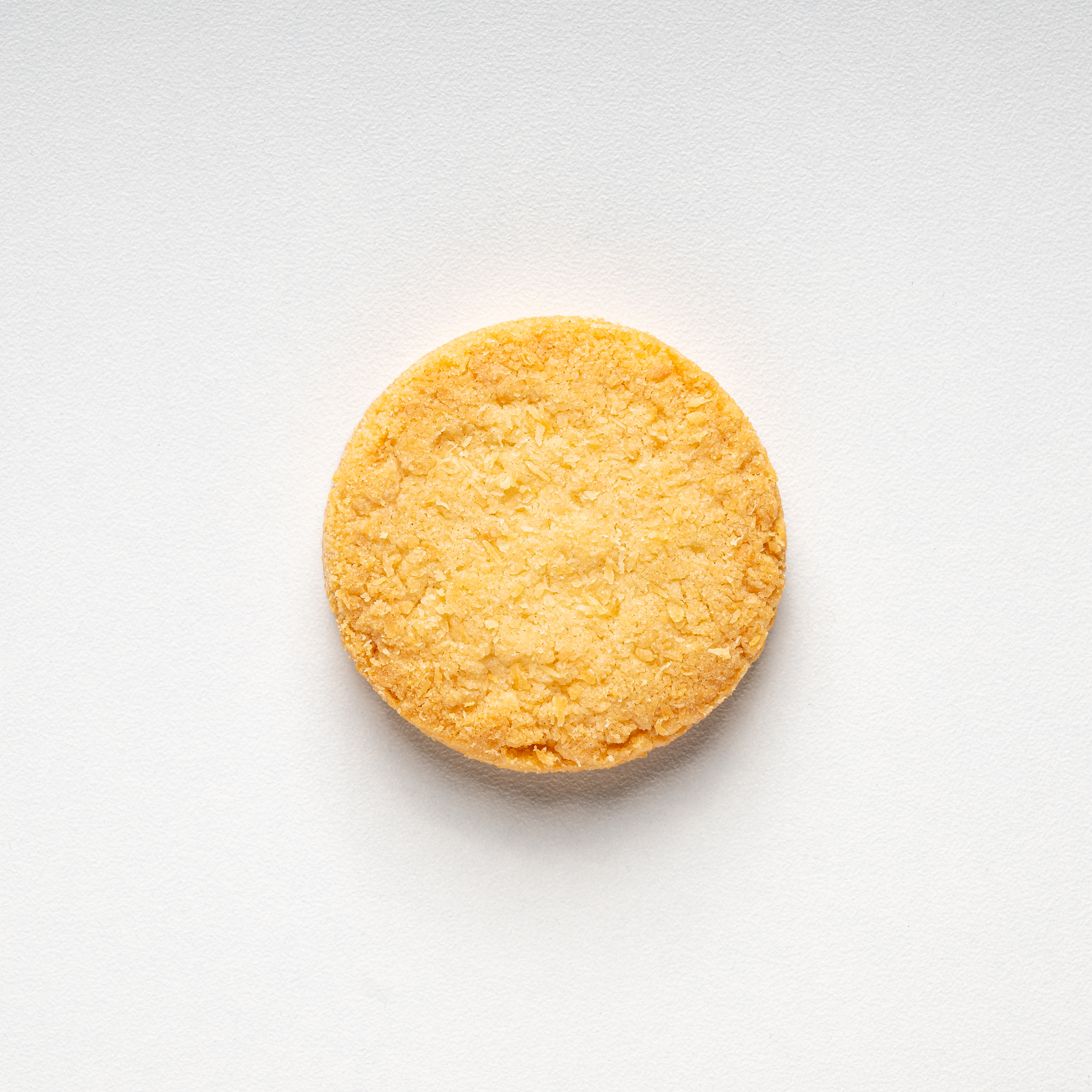 Round yellow cookie on a white background