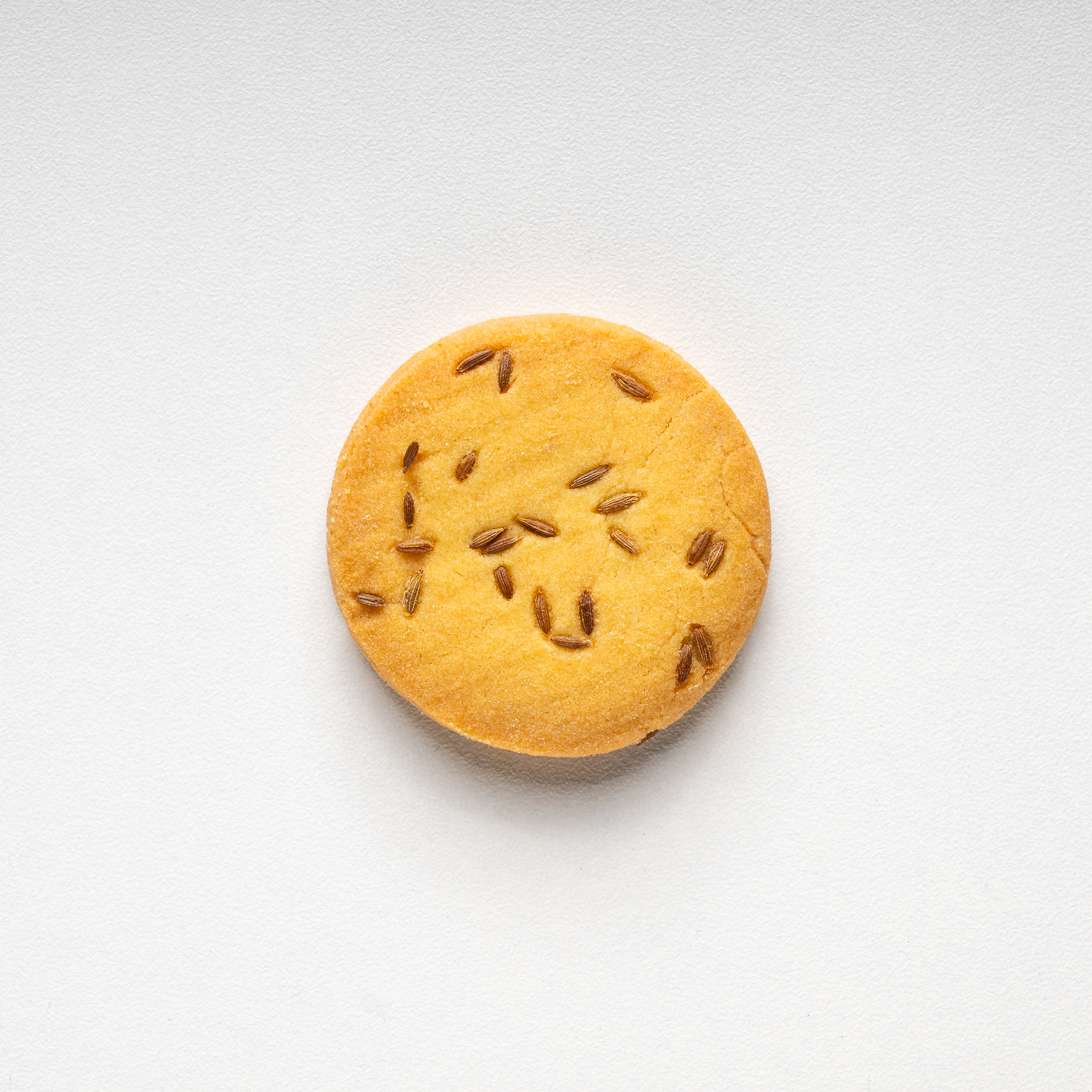 Round cookie with seeds on a white background