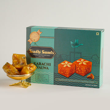 Box of Karachi Halwa with pieces of halwa on a white background