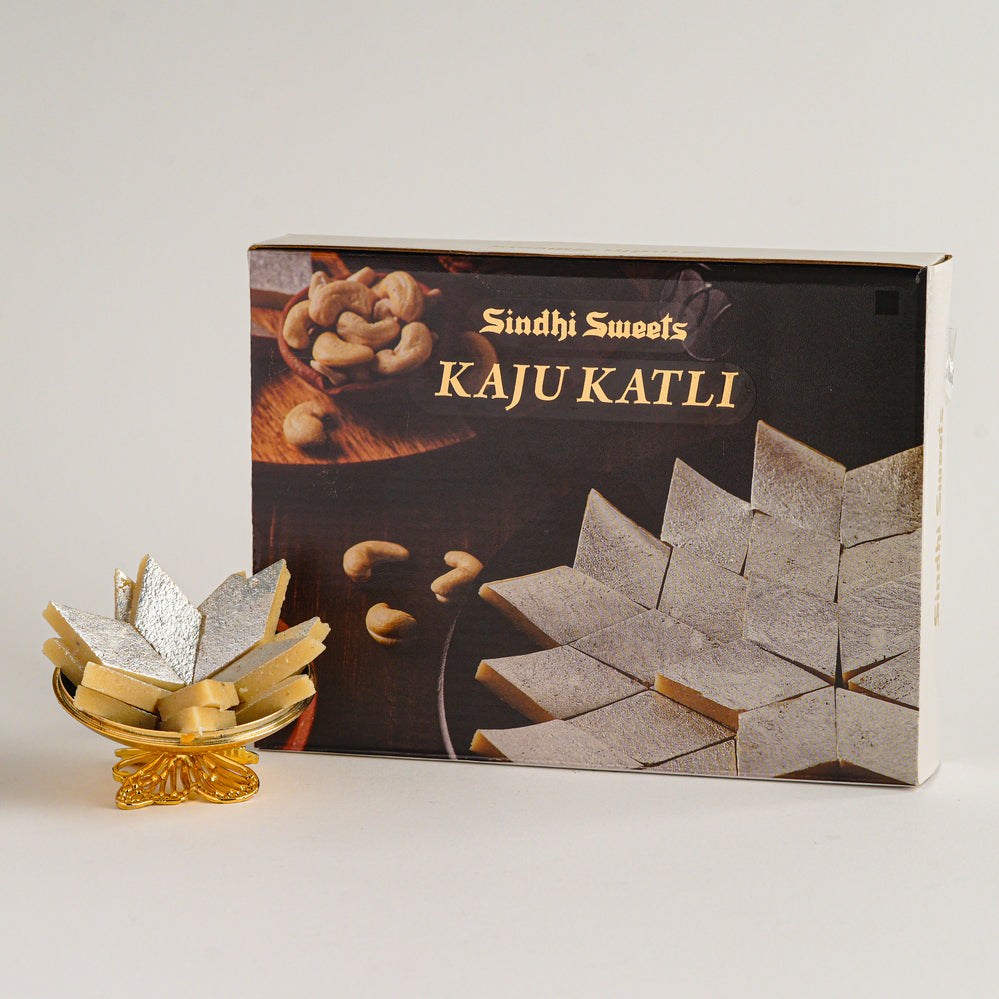 Box of Sindhi Sweets Kaju Katli with a small display of the product on a white background