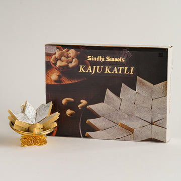 Box of Sindhi Sweets Kaju Katli with a small display of the product on a white background